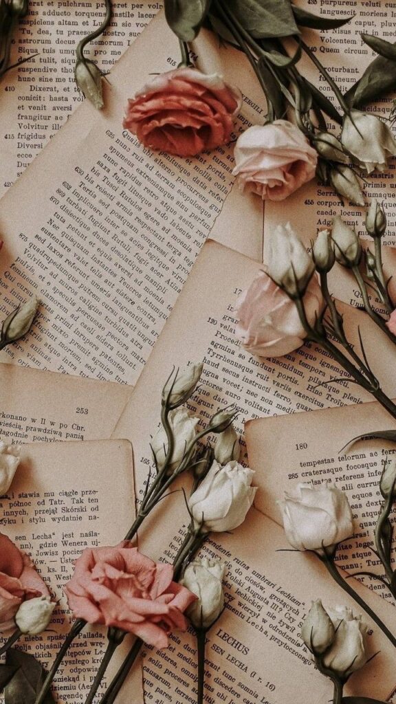 wallpaper para celular com paginas de livros espalhadas com flores 