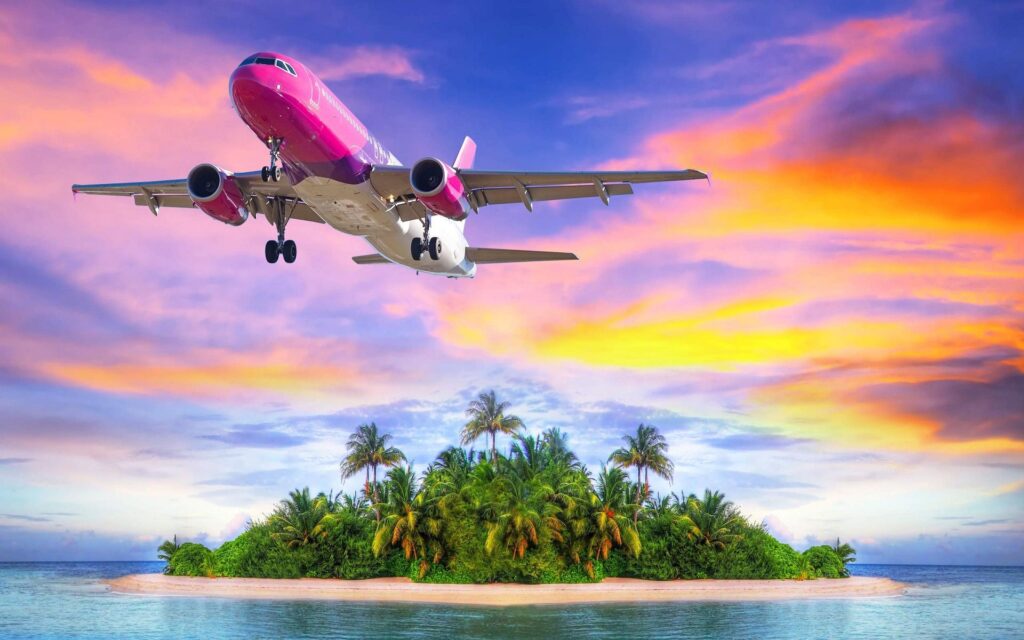 wallpaper para pc de um avião rosa passando por uma ilha e um lindo mar